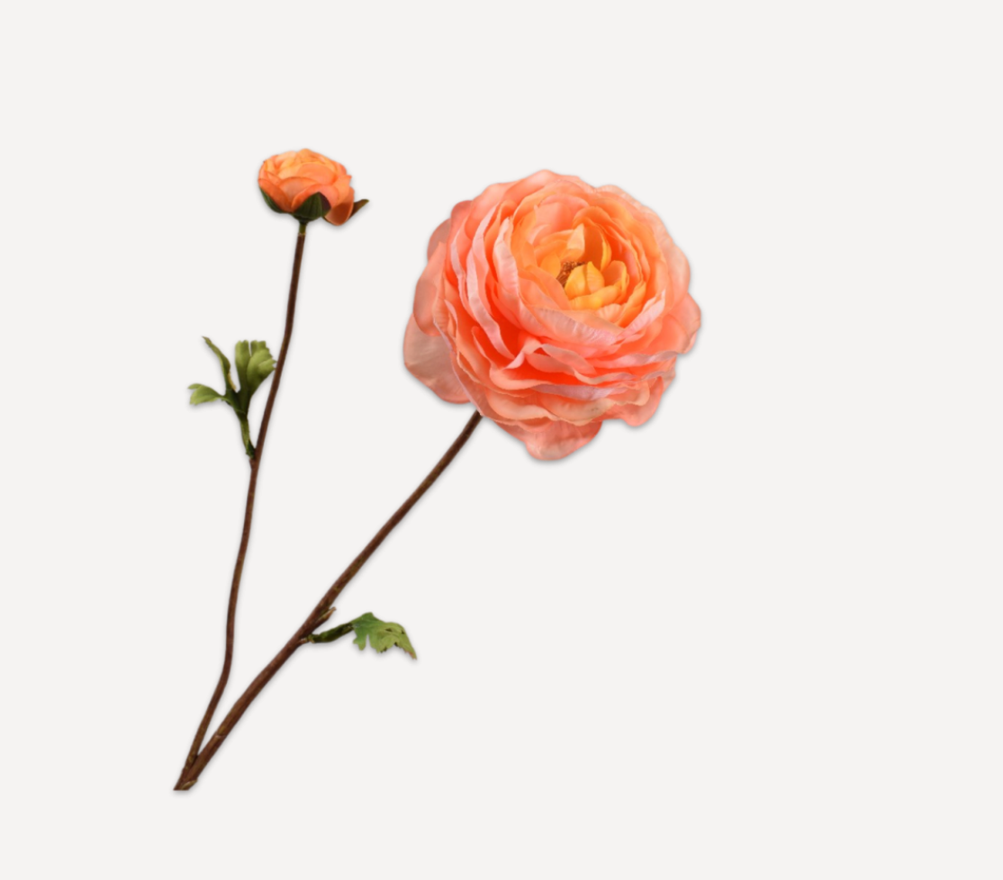 Front view product shot of a Silk-ka real-touch faux ranunculus spray featuring salmon ruffled petals, a closed bud, a brown textured stem, and green leaves isolated on a solid white background.