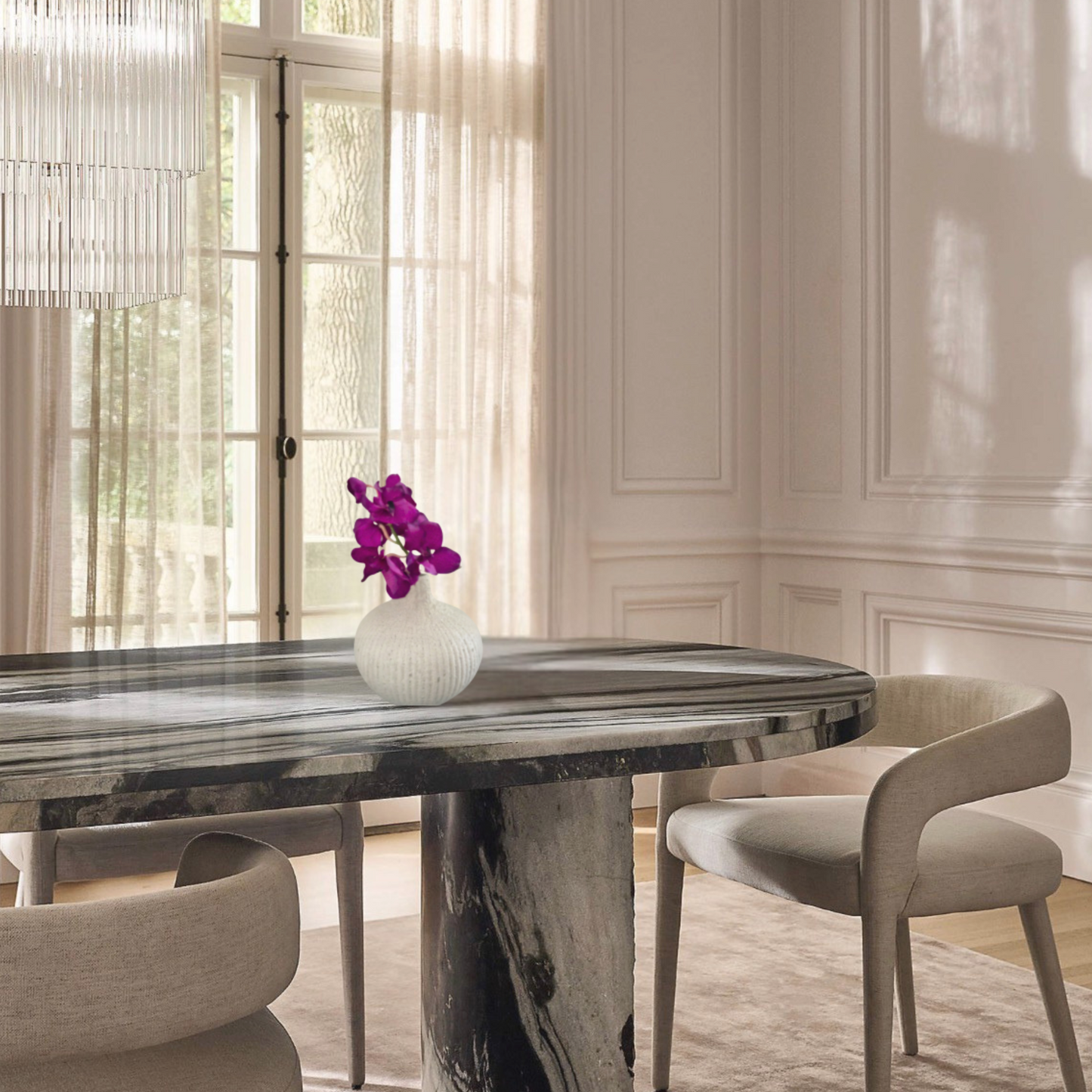 Dining room with a marble table and chairs, featuring a vase with Sik/artificial/faux Vanda in Stone vase.